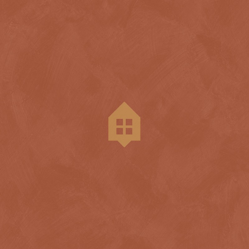 Papel pintado tierra de Siena con efecto de cal natural y textura mate, colección Chalk de Caselio.